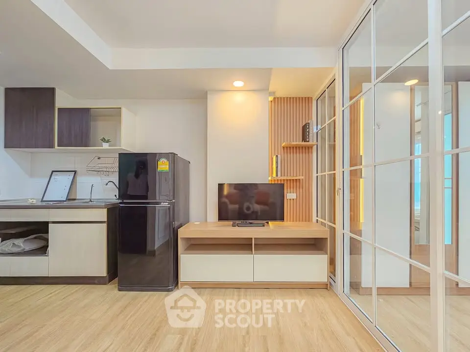 Modern living room with open kitchen and sleek design in a contemporary apartment.