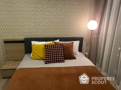 Cozy bedroom with stylish decor and warm lighting, perfect for relaxation and comfort.