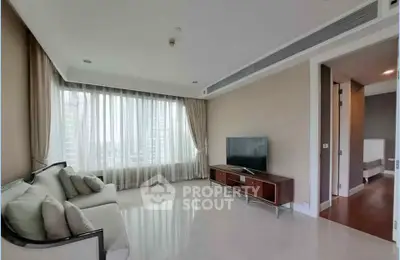 Spacious modern living room with large window and elegant furnishings