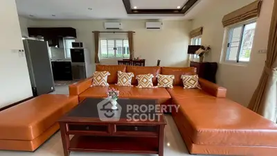 Spacious living room with modern orange sectional sofa and elegant decor