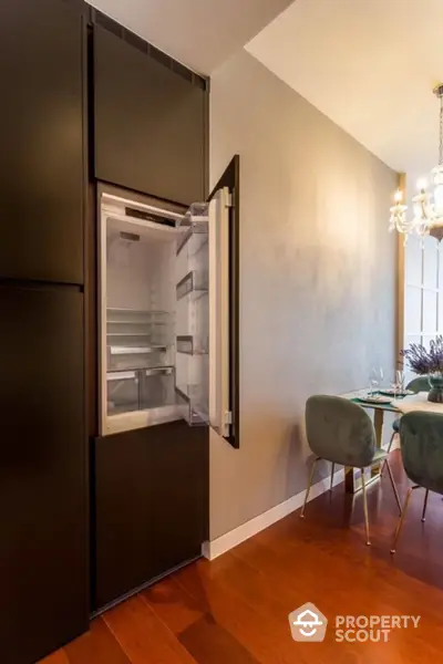 Modern kitchen with built-in fridge and elegant dining area