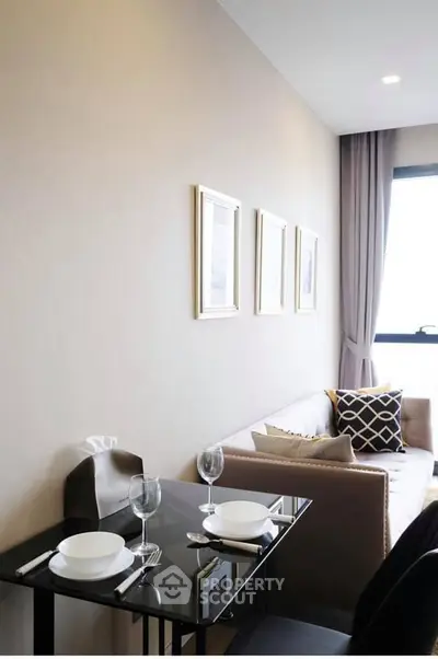 Modern living room with elegant dining setup and cozy sofa near window