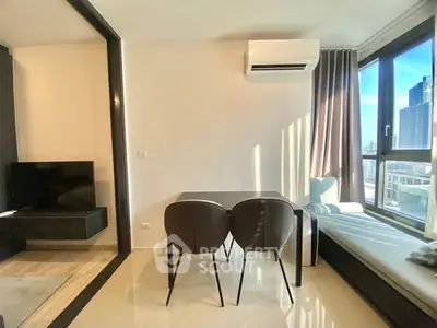 Modern living room with city view, sleek furniture, and ample natural light.