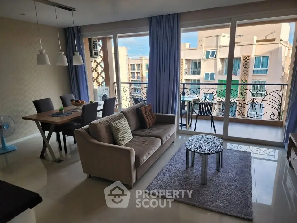 Spacious living room with modern decor and balcony view in luxury apartment