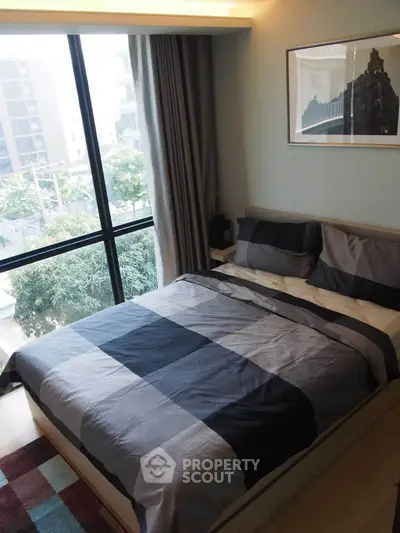 Modern bedroom with large window and stylish decor in urban apartment