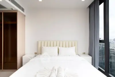Luxurious bedroom with city view and elegant decor in modern apartment