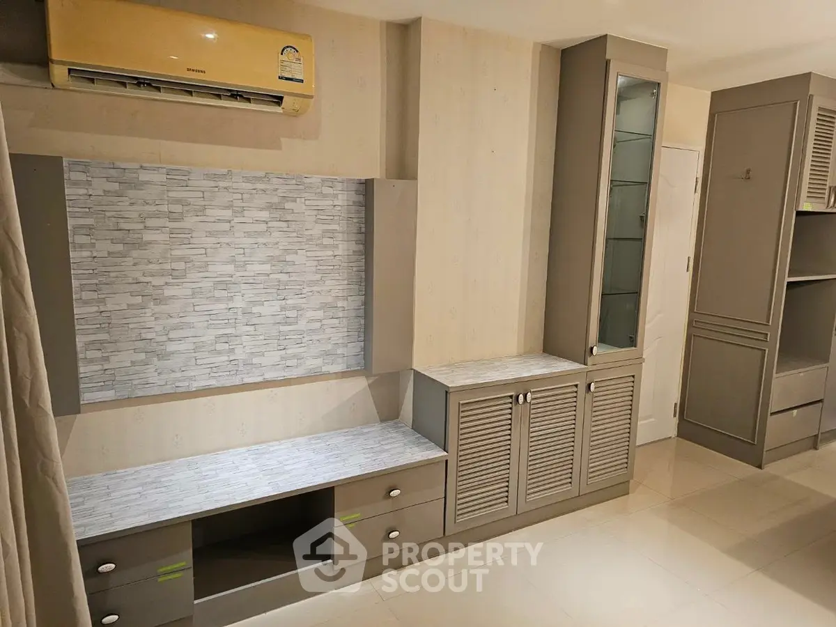 Modern living room with built-in storage and air conditioning unit