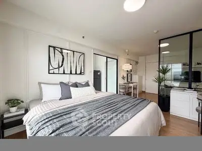 Modern bedroom with stylish decor and large bed in a bright apartment.