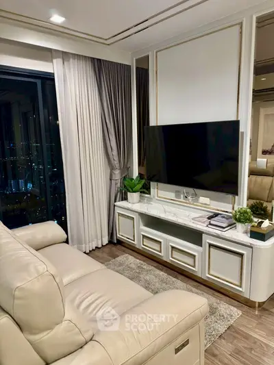 Luxurious living room with modern decor and city view, featuring a sleek TV setup and elegant furnishings.