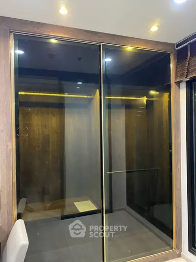 Luxurious modern elevator with sleek glass doors and ambient lighting