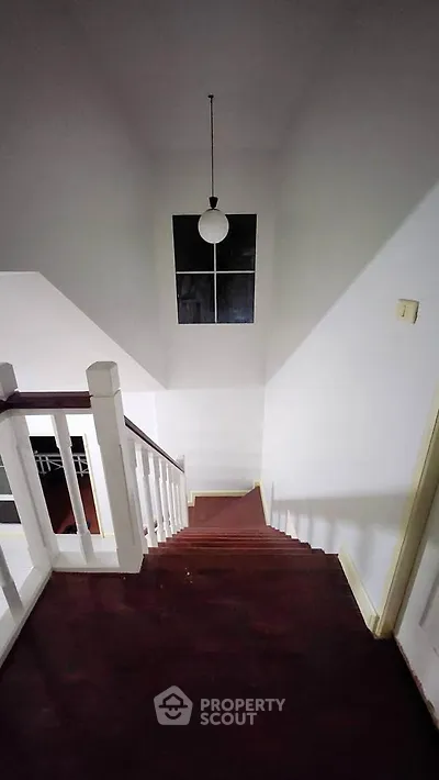 Elegant staircase with dark wood steps and modern lighting in a stylish home interior.
