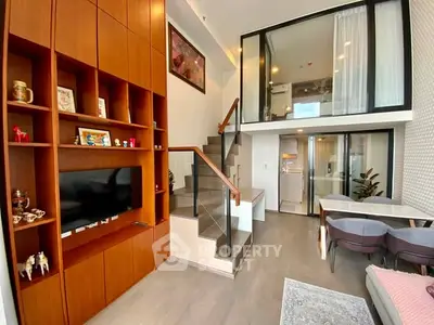 Modern duplex living room with stylish wooden shelving and open kitchen layout
