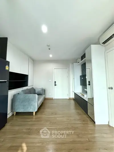 Modern living room with sleek design, featuring a comfortable sofa and stylish storage solutions.