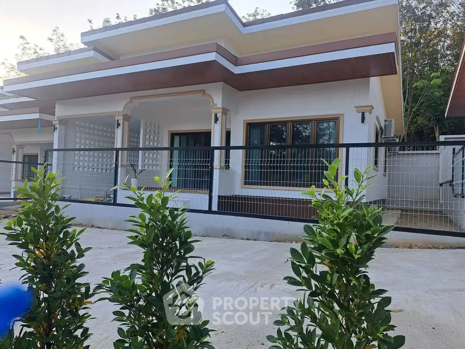 Modern single-story house with sleek design and spacious outdoor area.