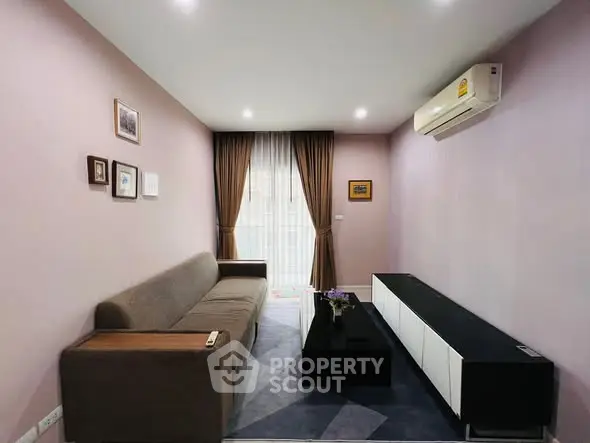 Modern living room with sleek furniture and air conditioning in a cozy apartment.