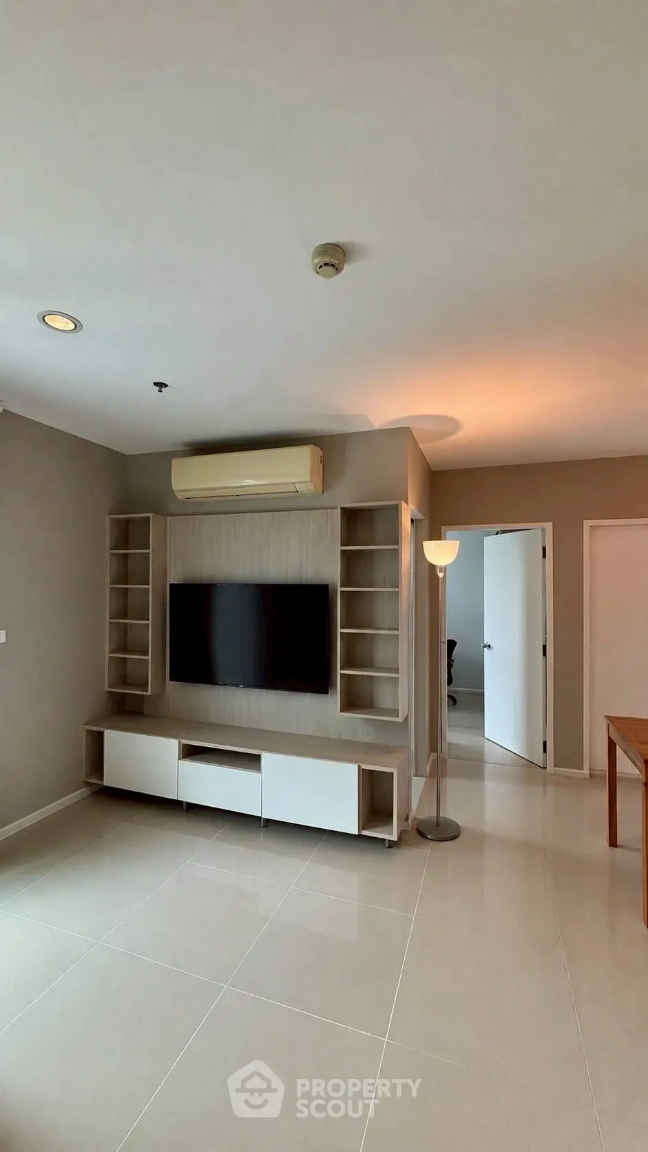 Spacious modern living room with sleek TV unit and ambient lighting