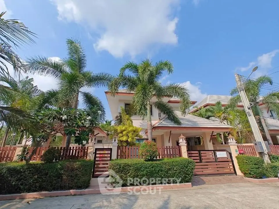 Stunning tropical villa with lush garden and palm trees, perfect for serene living.