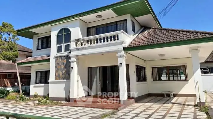 Stunning two-story house with tiled roof and spacious driveway in a serene neighborhood.