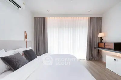 Elegant bedroom with modern decor and natural light