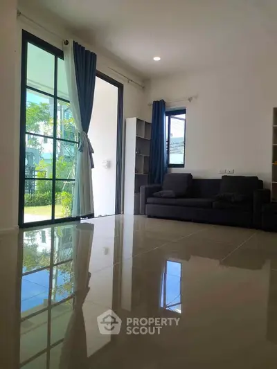 Spacious living room with large windows and modern decor