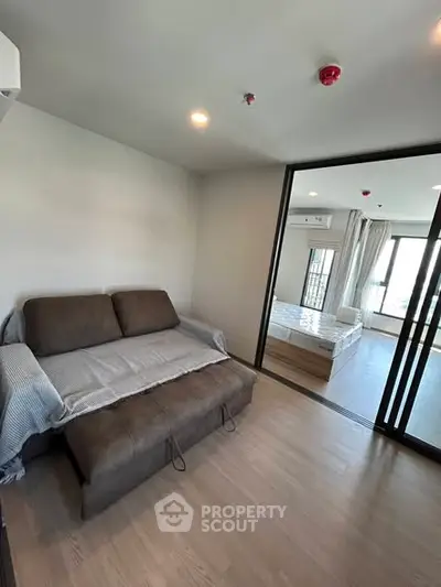 Modern apartment interior with cozy living area and bedroom view