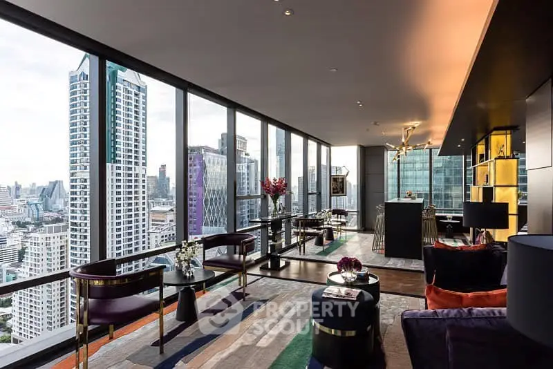 Luxurious high-rise living room with panoramic city views and modern decor.