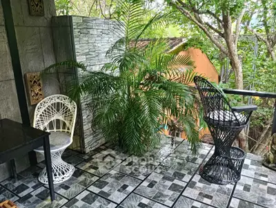 Charming balcony with stylish seating and lush greenery, perfect for relaxation and enjoying nature.