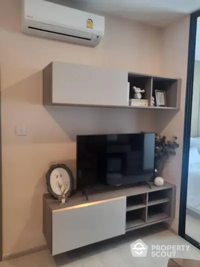 Modern living room with sleek TV unit and air conditioning