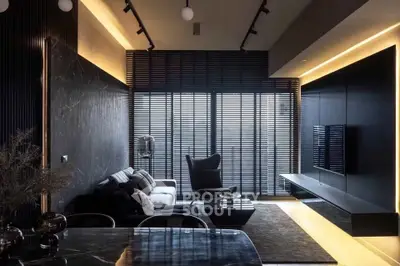Luxurious modern living room with sleek black decor and ambient lighting