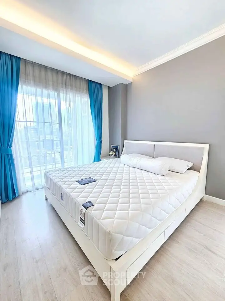 Bright and airy bedroom with modern decor and large window view