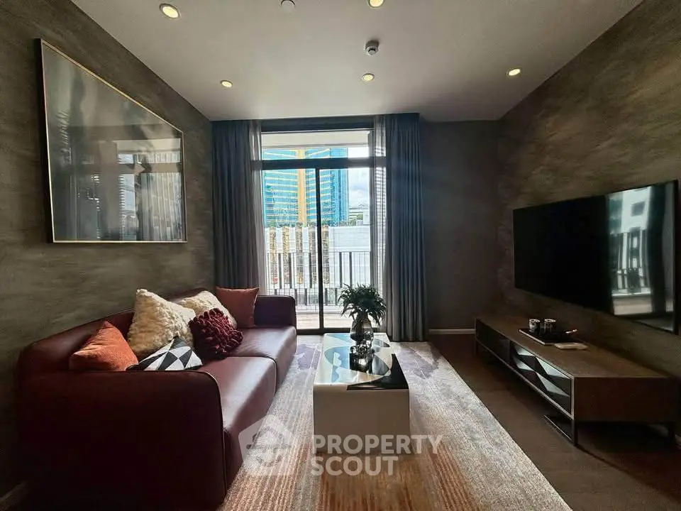 Modern living room with stylish decor and city view from balcony, featuring a sleek sofa and wall-mounted TV.
