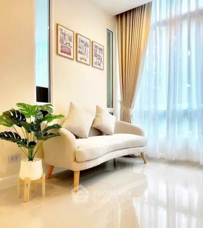 Bright living room with modern sofa and large window, perfect for relaxation and natural light.