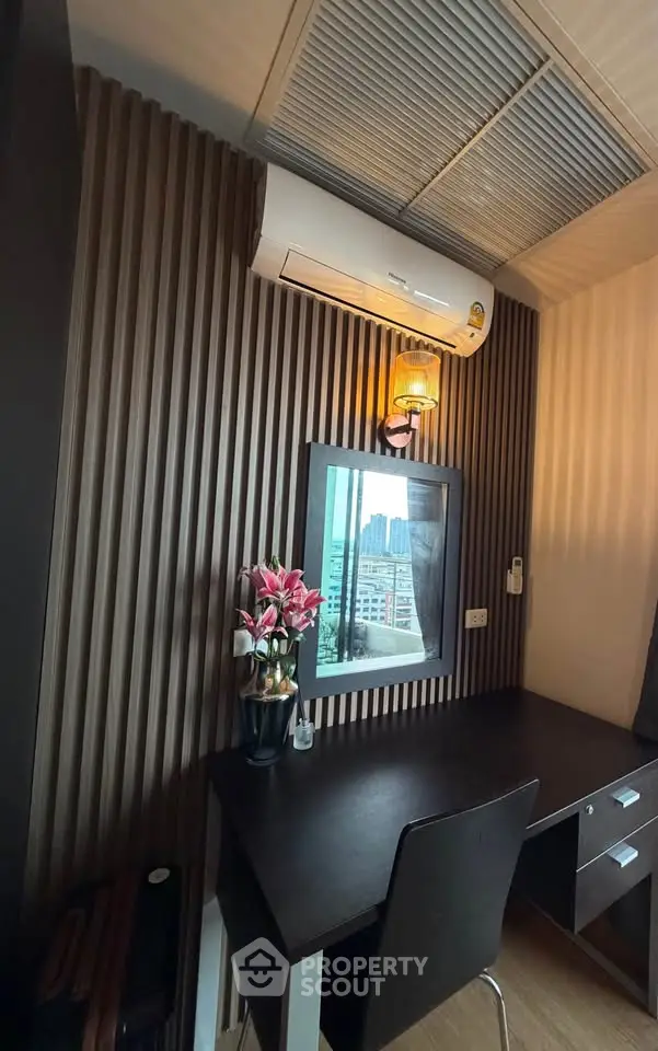 Modern study area with sleek desk, chair, and air conditioning, featuring a window view of the city skyline.