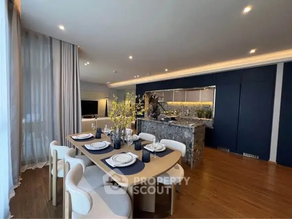 Luxurious open-plan living and dining area with elegant decor and modern kitchen.
