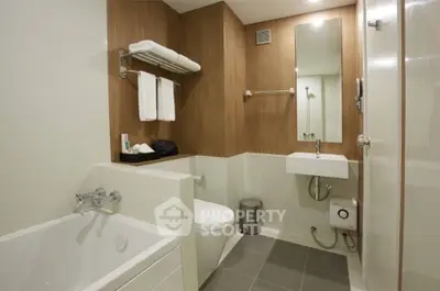 Modern bathroom with sleek fixtures and wooden accents in a contemporary apartment.