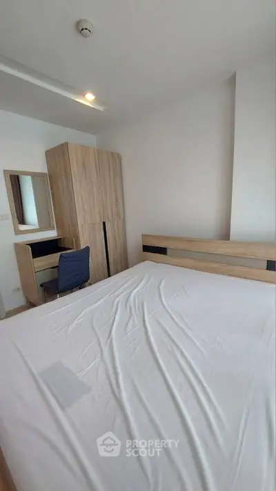 Modern bedroom with sleek wooden furniture and cozy ambiance