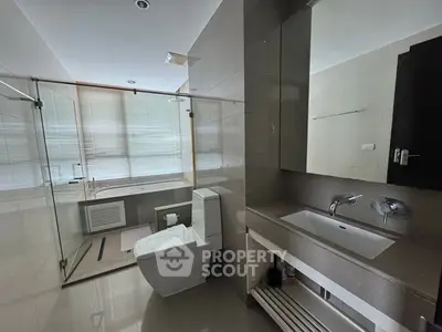 Modern bathroom with glass shower and sleek fixtures