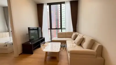 Modern living room with beige sofa and large window view