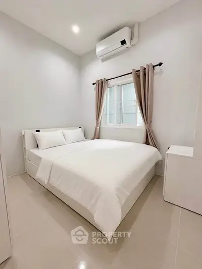 Cozy bedroom with modern decor and air conditioning in a stylish apartment.