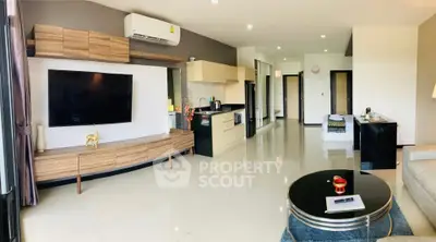 Spacious modern living room with open kitchen and sleek decor