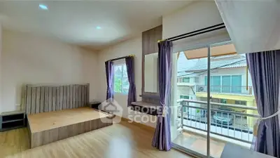 Spacious bedroom with balcony and natural light in modern home