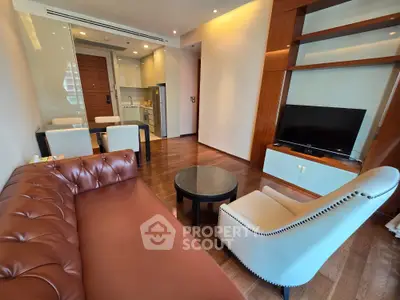 Modern living room with elegant furniture and open kitchen layout in a stylish apartment.
