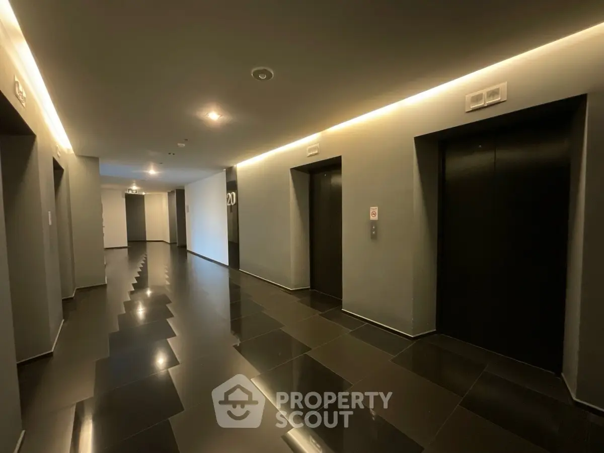 Modern building corridor with sleek elevators and polished flooring