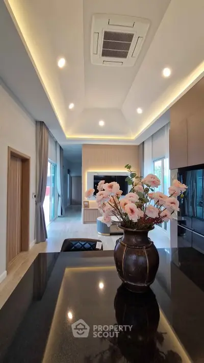 Luxurious modern living room with elegant decor and recessed lighting