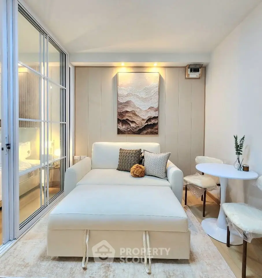 Modern living room with cozy seating and elegant decor in a stylish apartment.
