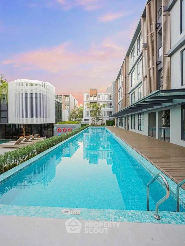 Luxurious modern apartment complex with stunning outdoor pool and stylish architecture.
