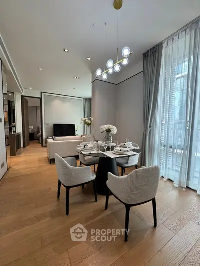 Elegant modern living room with dining area, featuring stylish furniture and large windows for natural light.