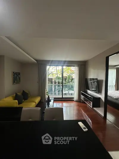 Spacious living room with modern decor and balcony view