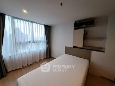 Modern bedroom with large window and minimalist decor