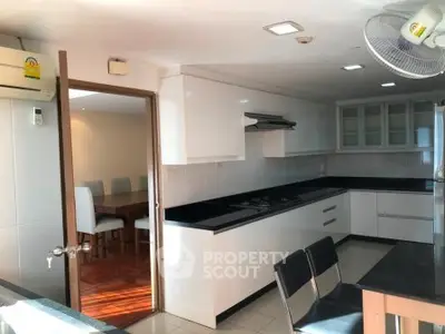 Modern kitchen with sleek black countertops and open layout design